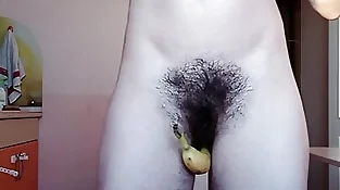 Holding banana with my unshaved pussy.